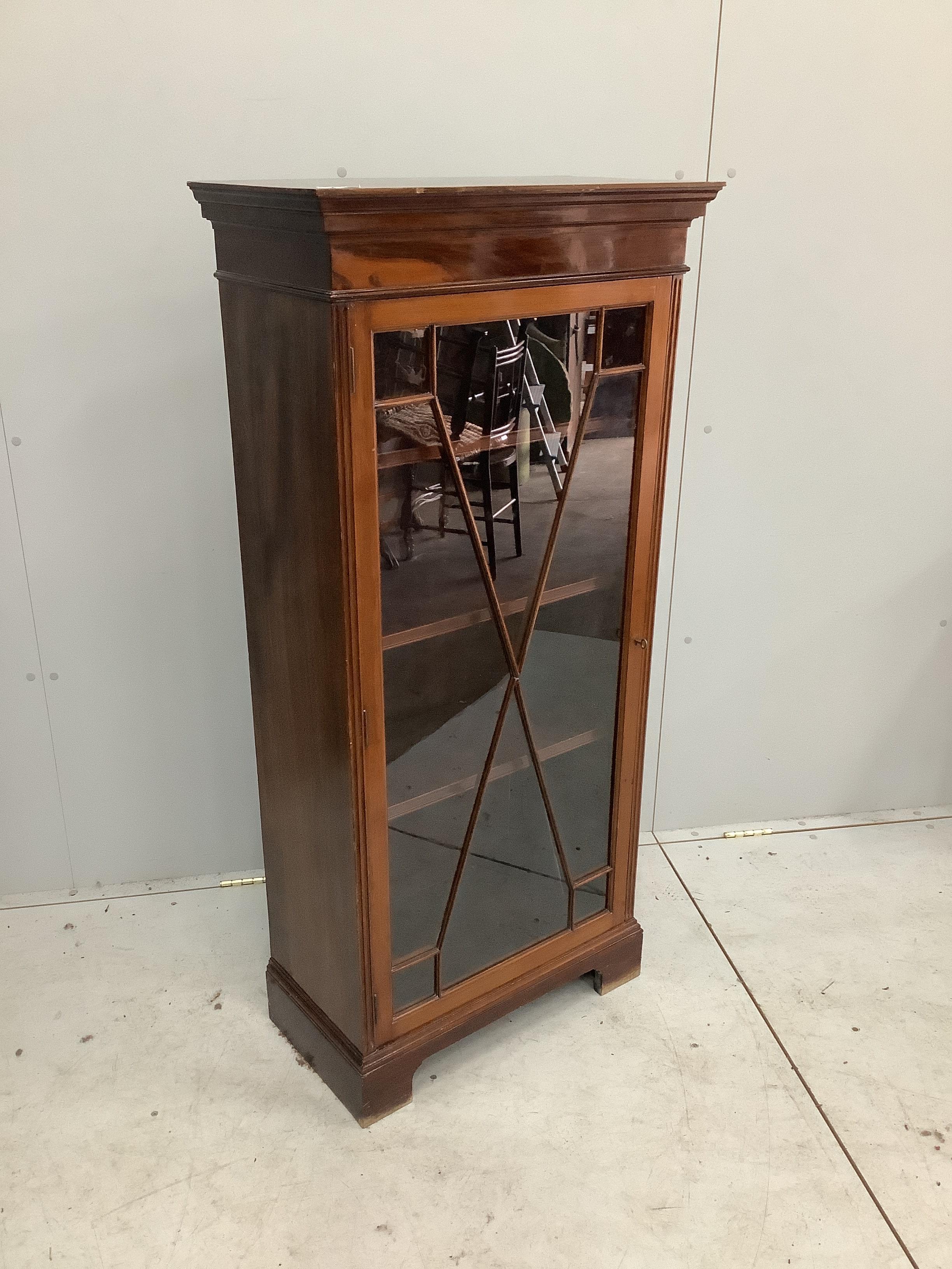 An Edwardian narrow mahogany glazed bookcase, width 63cm, depth 32cm, height 133cm